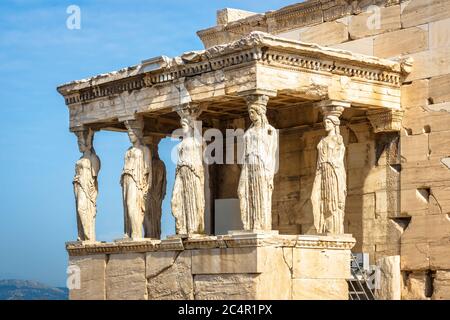 Caryatid Porch of the old Erechtheion temple, Athens, Greece. It is a famous landmark of Athens. Beautiful antique statues of Caryatids close-up. Anci Stock Photo