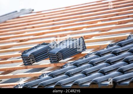 Black roof of burnt tiles reconstruction for the old house, building concept Stock Photo