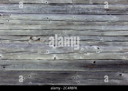 Wooden wall made of gray logs. Stock Photo