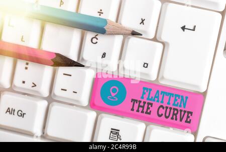 Writing note showing Flatten The Curve. Business concept for raising an awareness on slowing the rate of the infectious disease White pc keyboard with Stock Photo