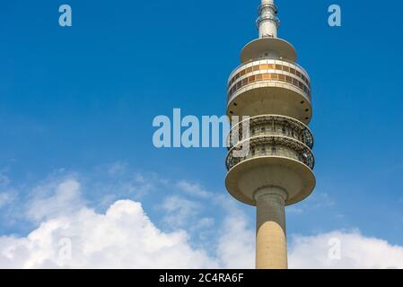 Olympic Tower or Olympiaturm close-up, Munich, Germany. Detail of top with revolving restaurant on blue sky background. This tower is a famous landmar Stock Photo