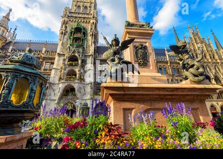 Marienplatz square in summer, Munich, Germany. It is top landmark of Munich. Luxury Mariensaule column closeup and Gothic Rathaus on background. Beaut Stock Photo