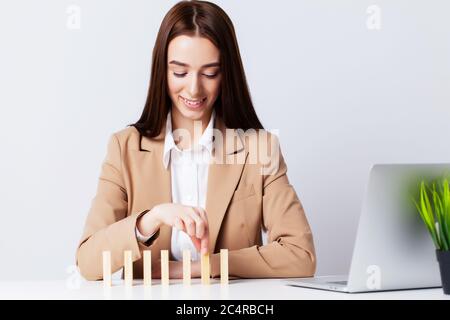 Beautiful young woman demonstrates on subjects the concept of business development Stock Photo