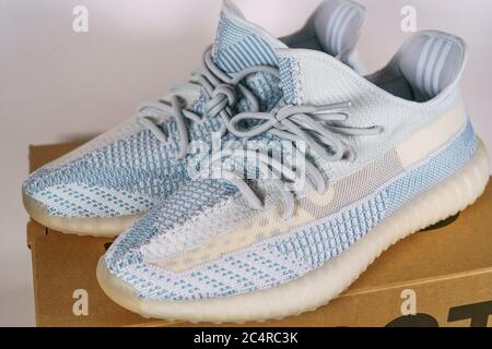 Moscow, Russia - June 2020 : Adidas Yeezy Boost 350 V2 Cloud White - Famous Limited Collection Fashion Sneakers by Kanye West and Adidas Collaboration, Trendy Sport Shoes. Stock Photo