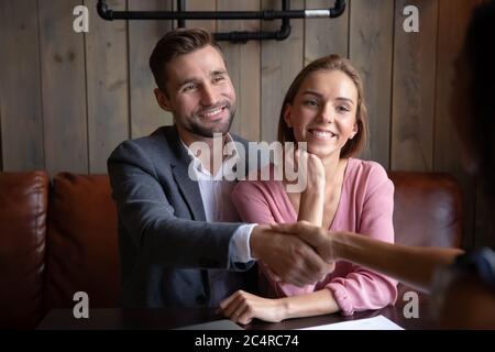 Spouses meet in cafe with travel agent accept tour offer Stock Photo