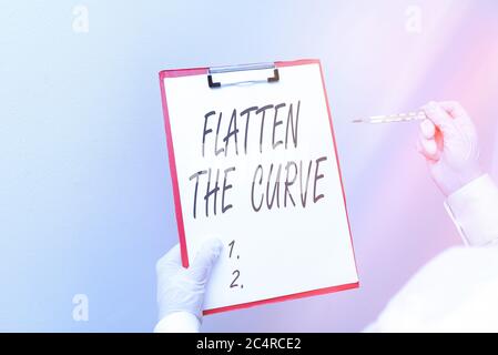 Writing note showing Flatten The Curve. Business concept for raising an awareness on slowing the rate of the infectious disease Laboratory blood test Stock Photo