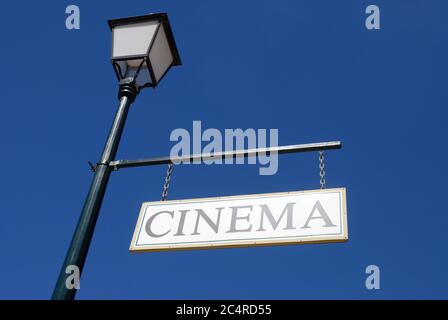 Old fashioned Cinema sign hanging from a lamp post against blue sky in the historic town of Charters Towers, Queensland, Australia Stock Photo
