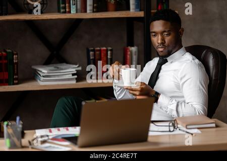 Handsome african business man working wirh laptop in modern office Stock Photo