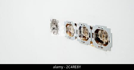 Paris, France - June 8, 2020: Row of multiple power sockets during installation renovation of whole electrical system in house with RJ45 internet cable - Busch-Jaeger Elektro GmbH made in Germany sign Stock Photo