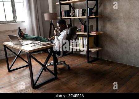 Handsome african business man working wirh laptop in modern office Stock Photo