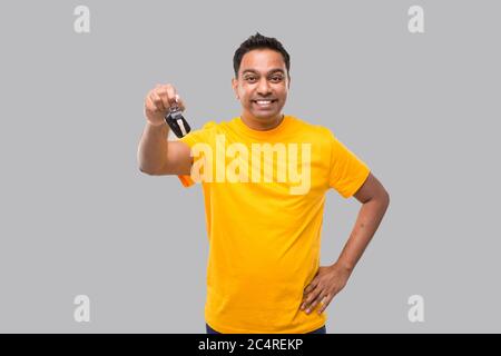 Indian Man Smilling Showing Car Keys Isolated. Driver Stock Photo