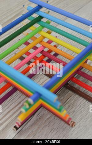 colored wooden pencils stacked in a pyramid. Colored pencils palette, rainbow texture Stock Photo