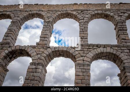 Detail view of the Segovia roman aqueduct with partly overcast sky in the background, Spain Stock Photo