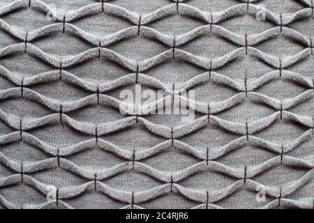 Gray knitted fabric with purple thread Stock Photo