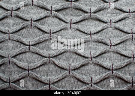 Gray knitted fabric with purple thread Stock Photo
