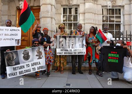 Protesters from the 'Africans in the diaspora assemble outside Christie's in London to demand the return of 'looted' African artefacts. Stock Photo