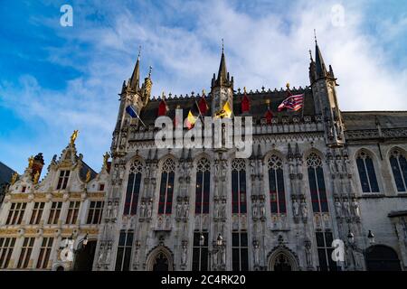 Burg Square during cloudy day, ancient building with flags and golden ornaments on the roof. Stock Photo