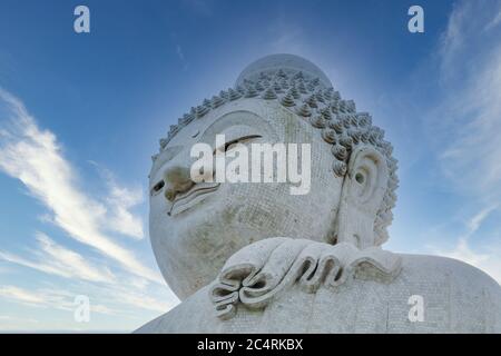 Close-up marble statue of a snow-white Big Buddha on the island of Phuket in Thailand. A giant Buddha figure made of marble bricks on Mount Nakaked in Stock Photo