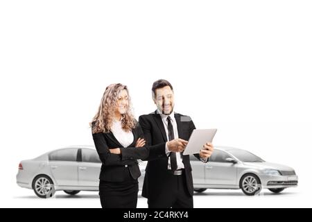 Car salesman showing a tablet to a saleswoman in a showroom isolated on white background Stock Photo