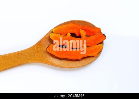 Cutting of turmeric roots on wooden spoon on white background. Stock Photo