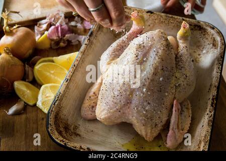 Prepping lemon and garlic chicken recipe for roasting Stock Photo