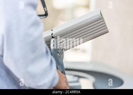 Worker Cutting Aluminum Rain Gutter With Heavy Shears. Stock Photo