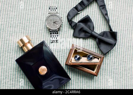 Groom accessories. Bow tie, perfume, cufflinks, wrist watch. Preparati Stock Photo