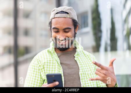 young man with green cap and green plaid shirt Stock Photo