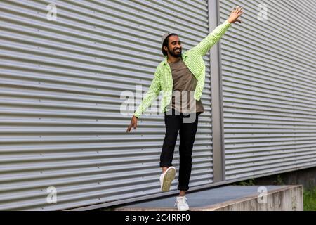 young man in front corrugated iron wall Stock Photo