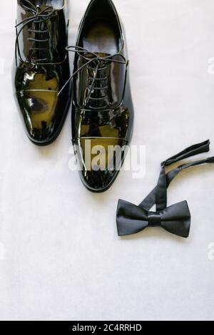 Groom shoes and bow tie. Preparations for the wedding day. Stock Photo