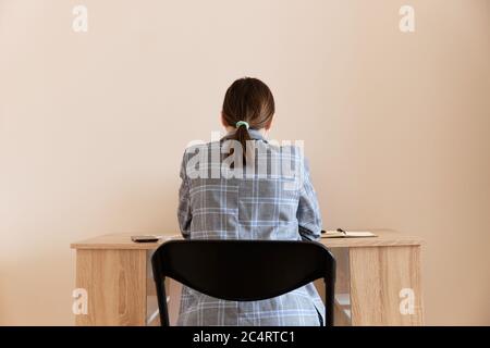 young woman in a suit working at home at her workplace Stock Photo