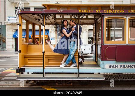 Couple dancing on a cable car in San Francisco. Stock Photo