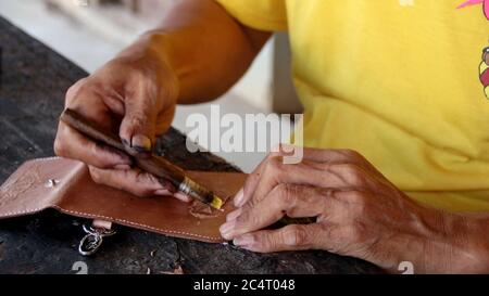making fashion products made from high-quality cow leather from traditional craftsmen in Java, with selective focus image Stock Photo