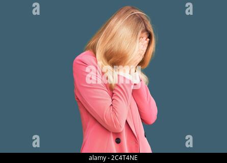 Young beautiful blonde woman wearing elegant clothes with sad expression covering face with hands while crying. depression concept. Stock Photo