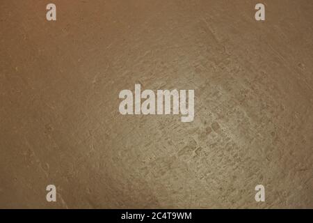 Gold-colored stone background or texture; Surface of the golden stone wall for use as a background Stock Photo