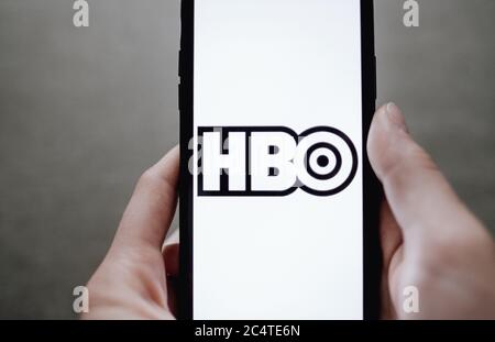 HBO logo on iphone screen in hand. Stock Photo