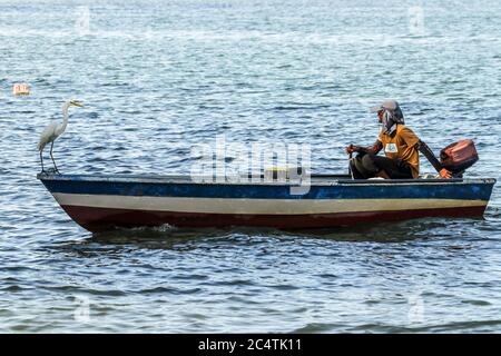 Small fishing boats and cargo ships in Likas Bay kota Kinabalu Sabah Malaysia Stock Photo