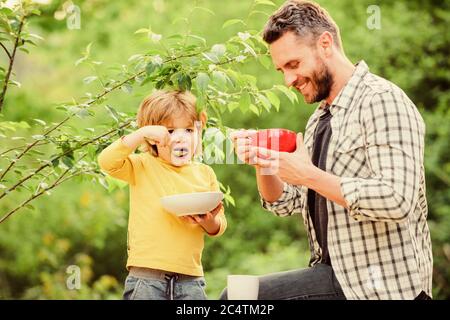Nutrition habits. Family enjoy homemade meal. Healthy breakfast. Father son eat food. Little boy and dad eat. Nutrition kids and adults. Tasty porridge. Organic nutrition. Healthy nutrition concept. Stock Photo
