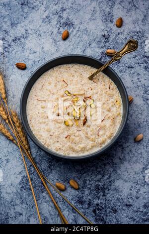 Daliya kheer or Dalia Payasam – Broken or Cracked wheat and milk porridge with sugar cooked in Indian way. Dalia is a popular breakfast cereal in Nort Stock Photo