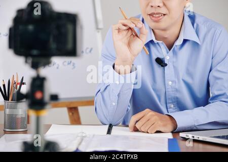Cropped image of teacher recording lesson and explaining difficult topic Stock Photo