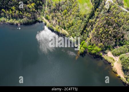 aerial view of forest and blue lake with clouds reflection. Vyacha lake, Belarus. Stock Photo