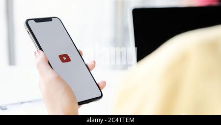 CHIANG MAI, THAILAND - MAR 7 ,2020: Woman holding iPhone Xs with Youtube apps on screen. YouTube is the popular online video sharing website. Stock Photo