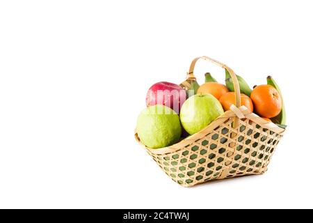 orange, green guava, banana and red apple in bamboo wicker basket on white background fruit health food isolated Stock Photo