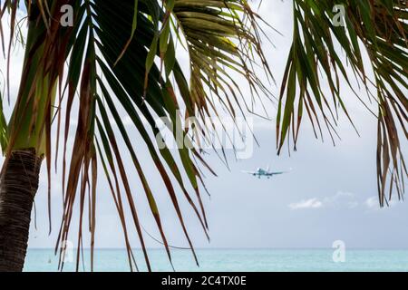 Selective focus shot of a plane coming in to land on the Caribbean island of Sint Maarten Stock Photo