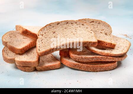 Macrophotography of green mildew on a stale bread. Surface of moldy bread. Spoiled bread with mold. Moldy fungus on rotten bread. Top view. Stock Photo