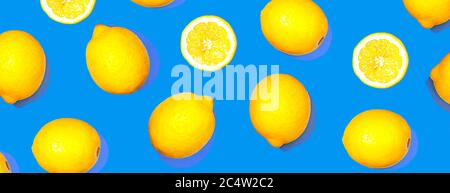Pattern with lemon fruits. Tropical abstract geometric balance citrus on classic blue color background. Trendy summer pattern. Minimal fashion concept. Flat lay, close up. Stock Photo