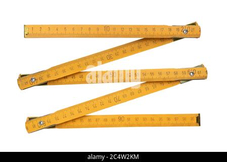 Traditional yellow wooden folding rule, isolated on white background Stock Photo