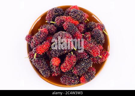 sweet ripe mulberry in  brown basket on white background healthy mulberry fruit food isolated Stock Photo