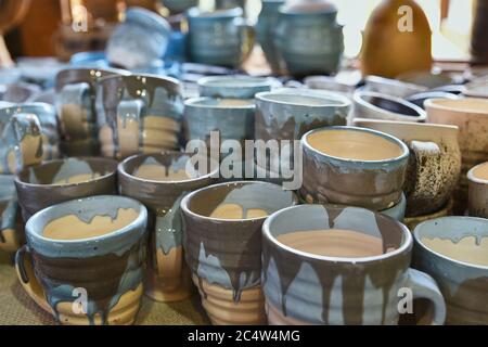 Many colorful ceramic hand made cups, top view. Handmade craft Stock Photo