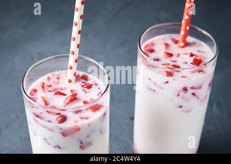 Two glasses with strawberry milk smoothie on dark background Stock Photo